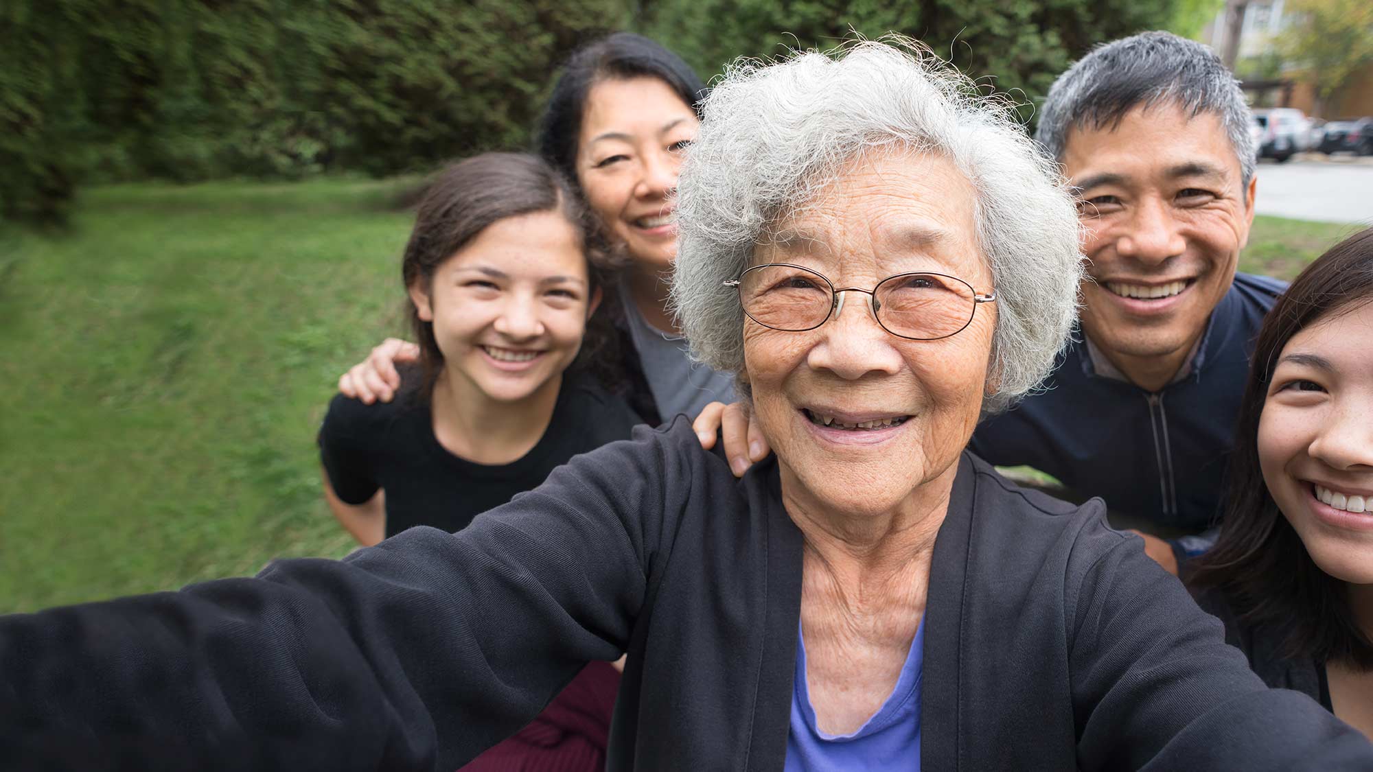 Asian American family taking a selfie outside