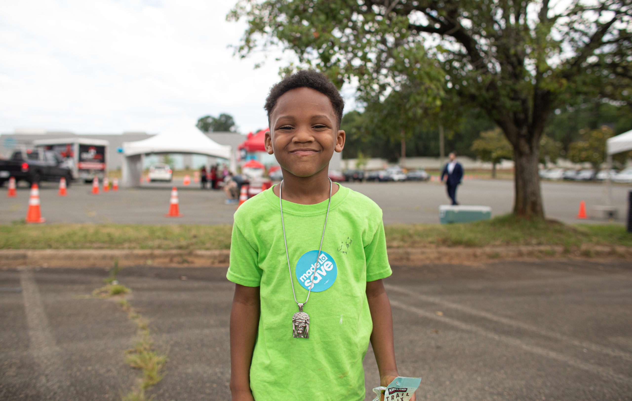 Image of boy wearing a green shirt and smiling